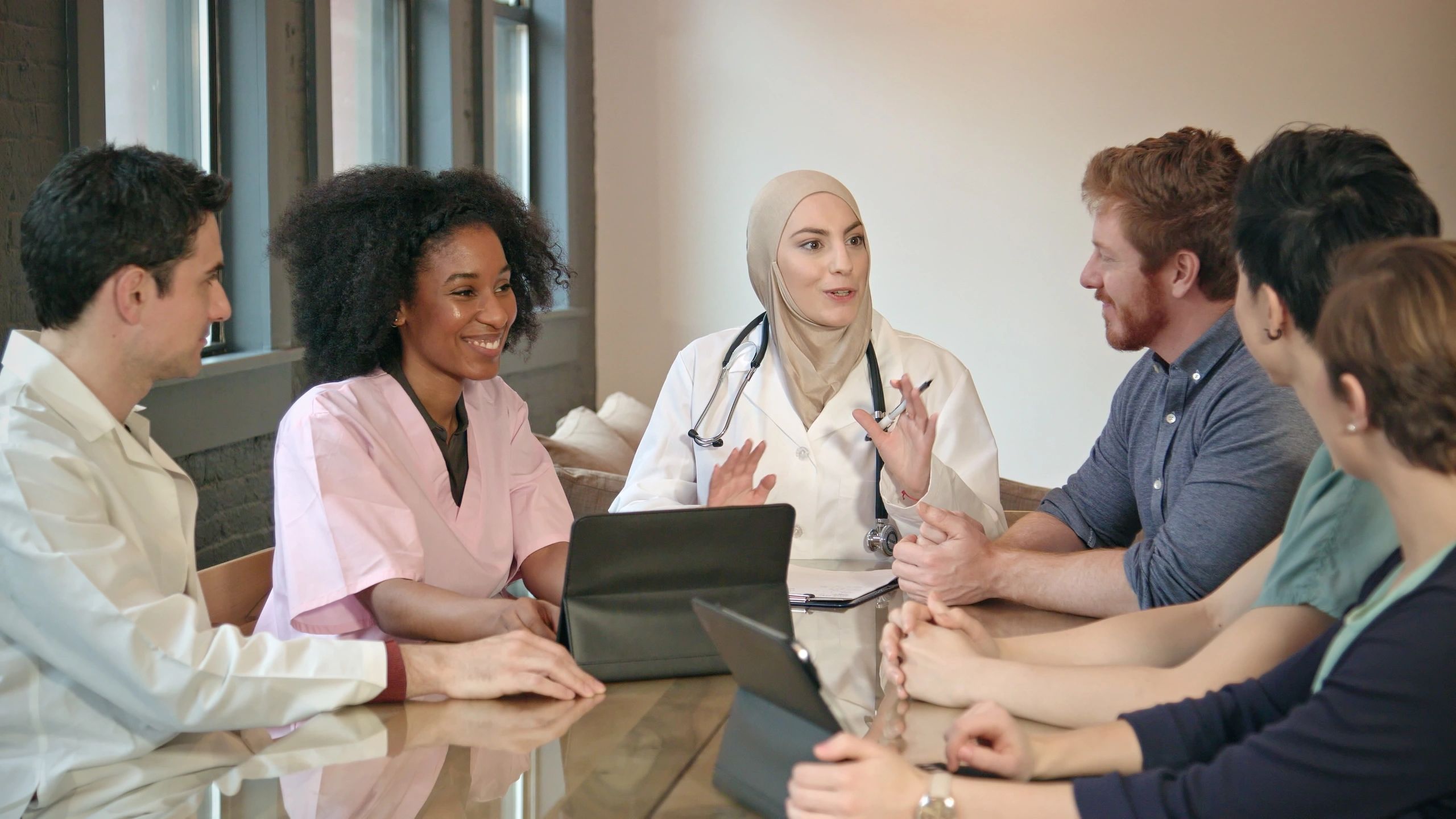 Healthcare administration team meeting to review accounts and reporting